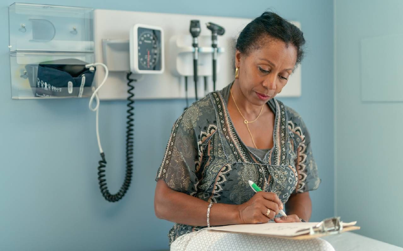 A snowbird filling out paperwork before a medical appointment. Next Avenue, health care,