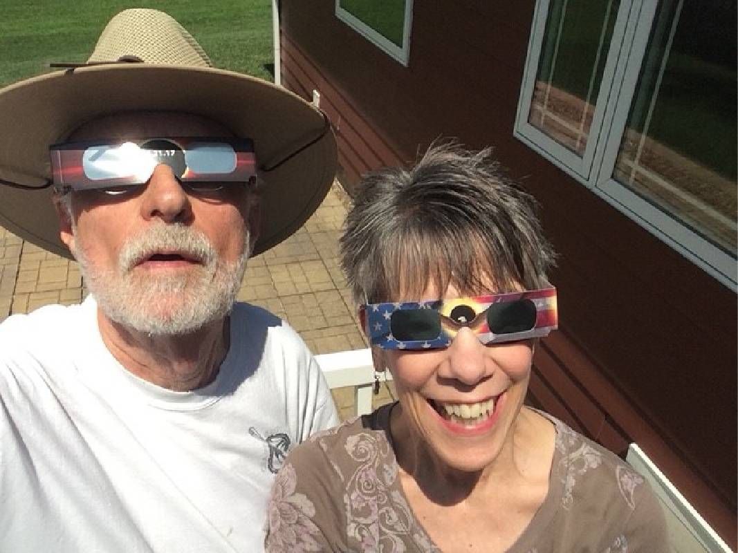 Two people wearing glasses during a solar eclipse. Next Avenue