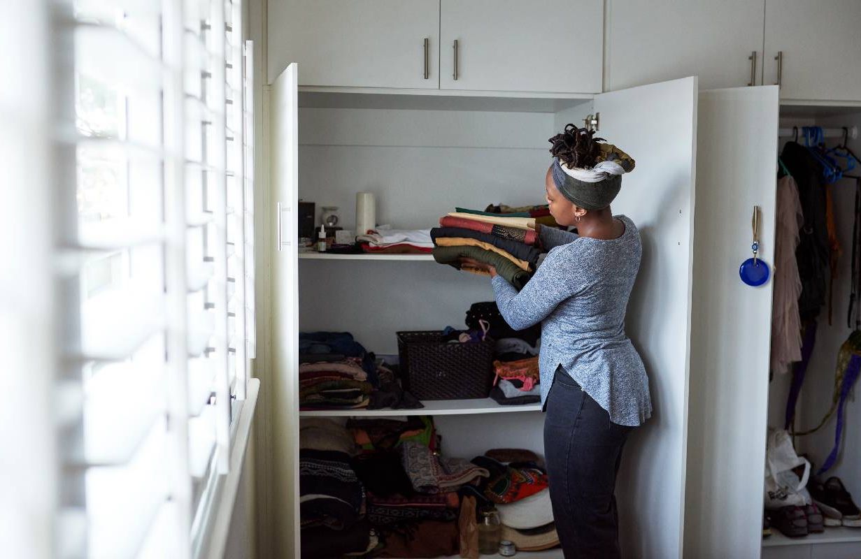 A woman clearing out her closet and replacing things. Next Avenue, closet therapy