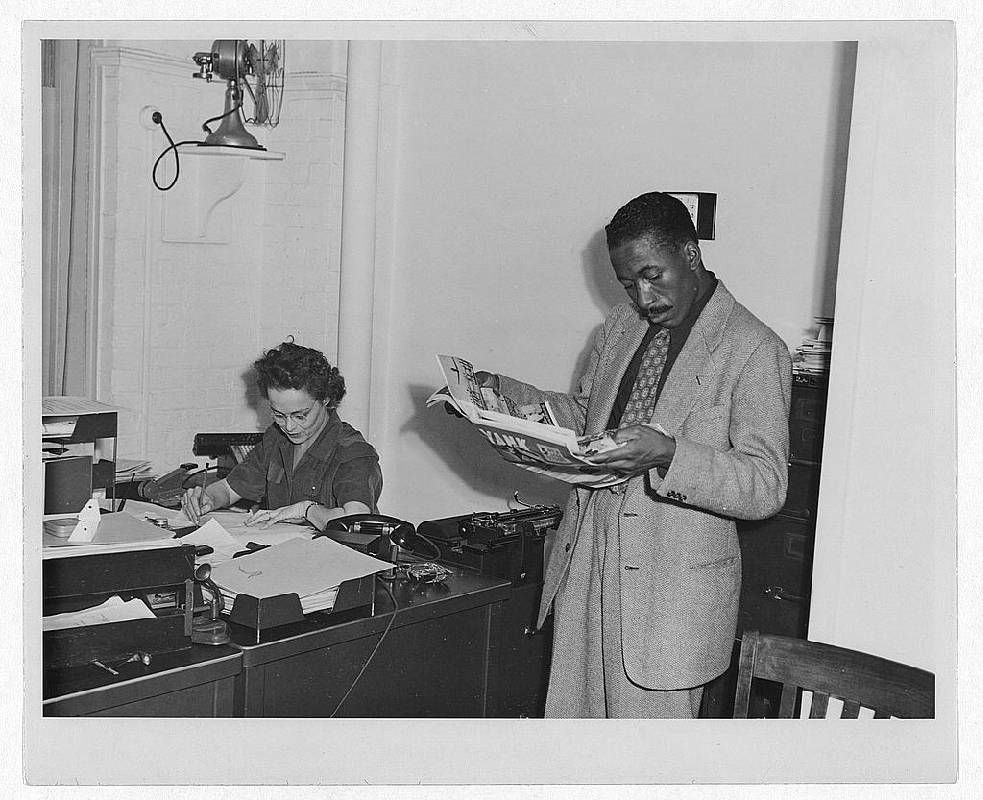 A black and white photograph of two people in an office. Next Avenue, Gordon Parks, Photography