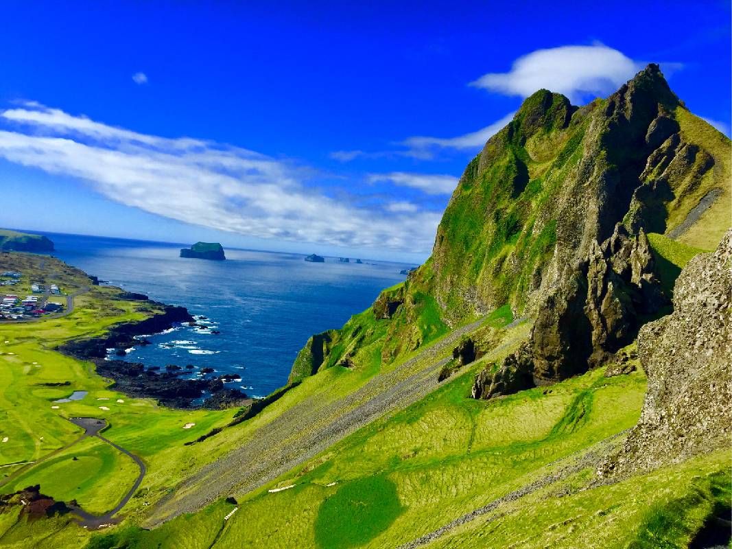 Mountains with green grass. Next Avenue, travel to Iceland