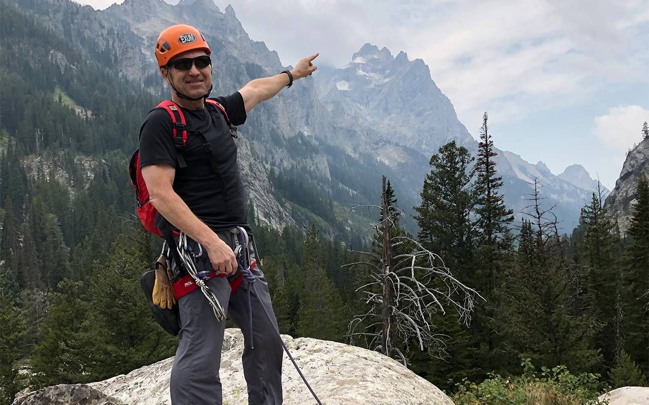 A man pointing at a mountain range. Next Avenue, liquid biopsy, cancer