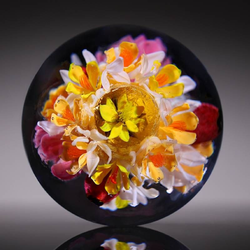 A glass ball with flowers inside. Next Avenue, glass art, Paul Stankard