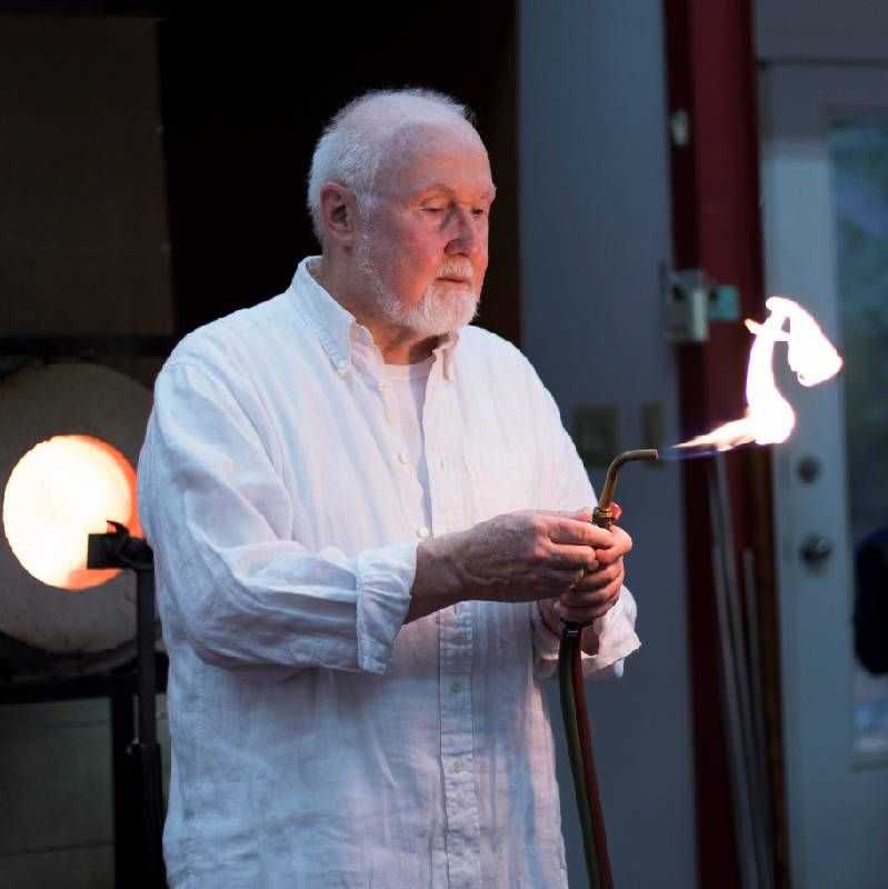 A man holding a torch for blowing glass. Next Avenue, glass art, Paul Stankard