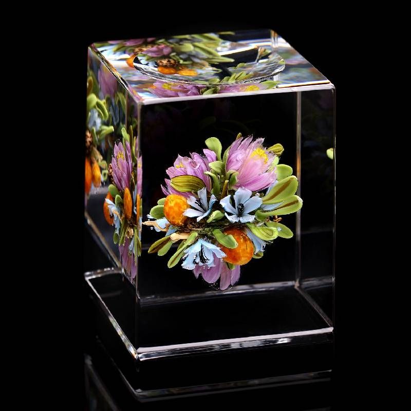 A glass cube with flowers inside. Next Avenue, glass art, Paul Stankard