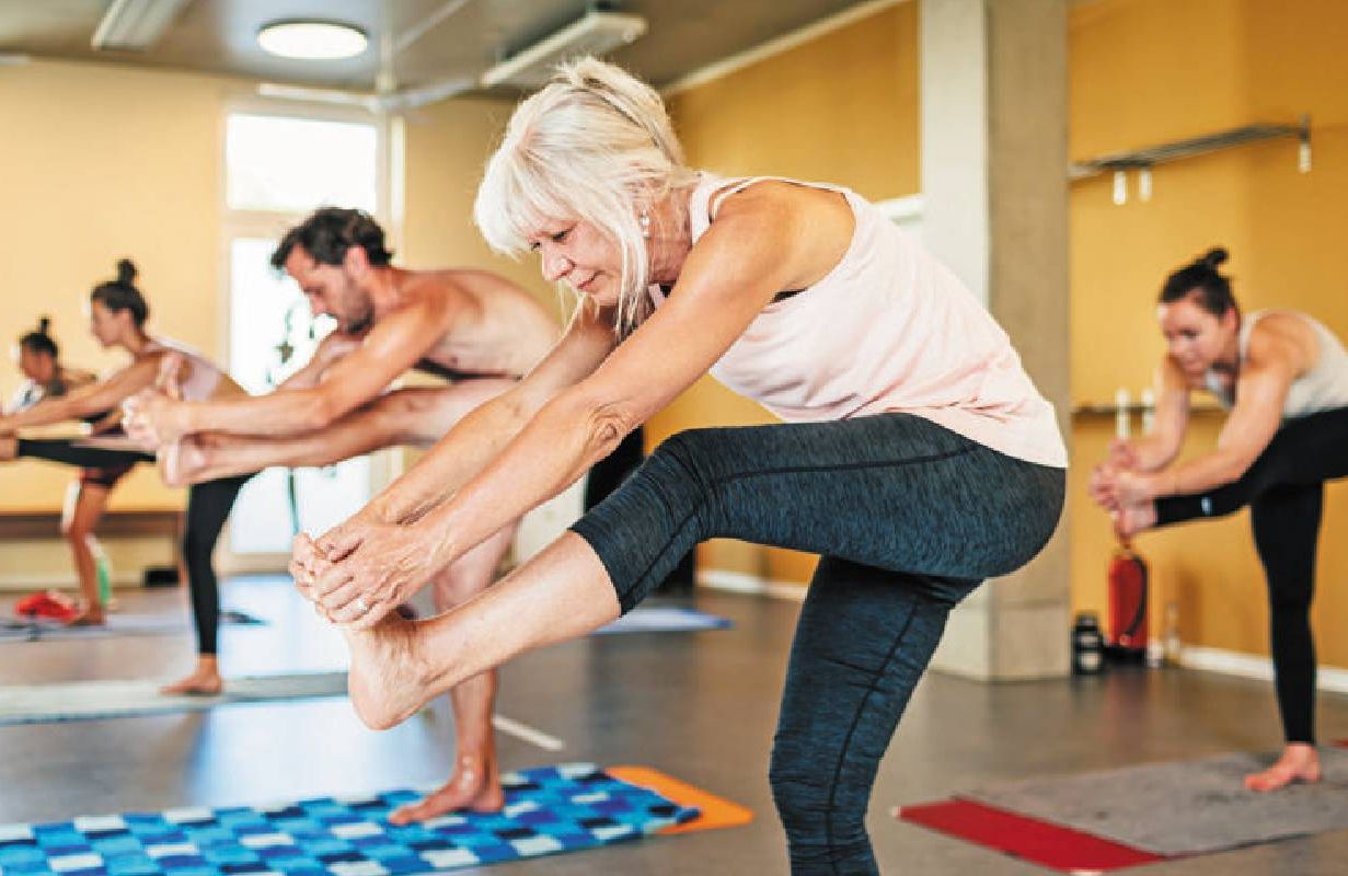 A woman who is over 50 during a hot yoga class. Next Avenue, yoga studio after 50