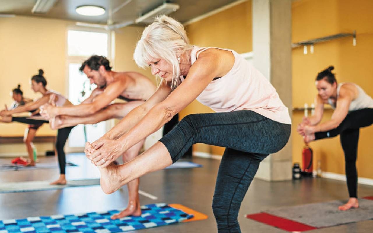 A woman who is over 50 during a hot yoga class. Next Avenue, yoga studio after 50