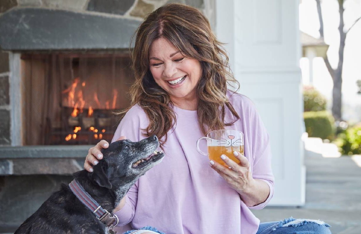 Valerie Bertinelli smiling with her dog. Next Avenue, indulge