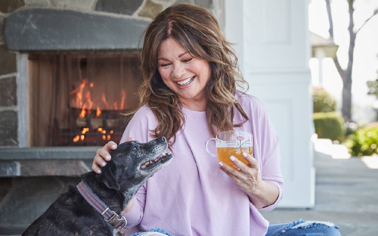 Valerie Bertinelli smiling with her dog. Next Avenue, indulge