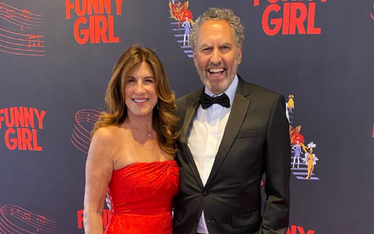 Two people smiling on a red carpet. Next Avenue, career, broadway producer