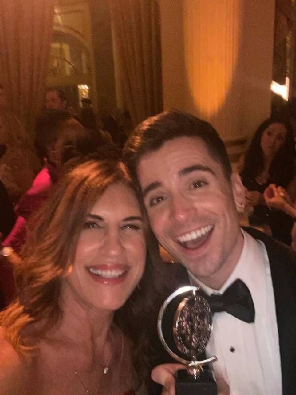 Two people smiling while holding a Tony award. Next Avenue, career, broadway producer