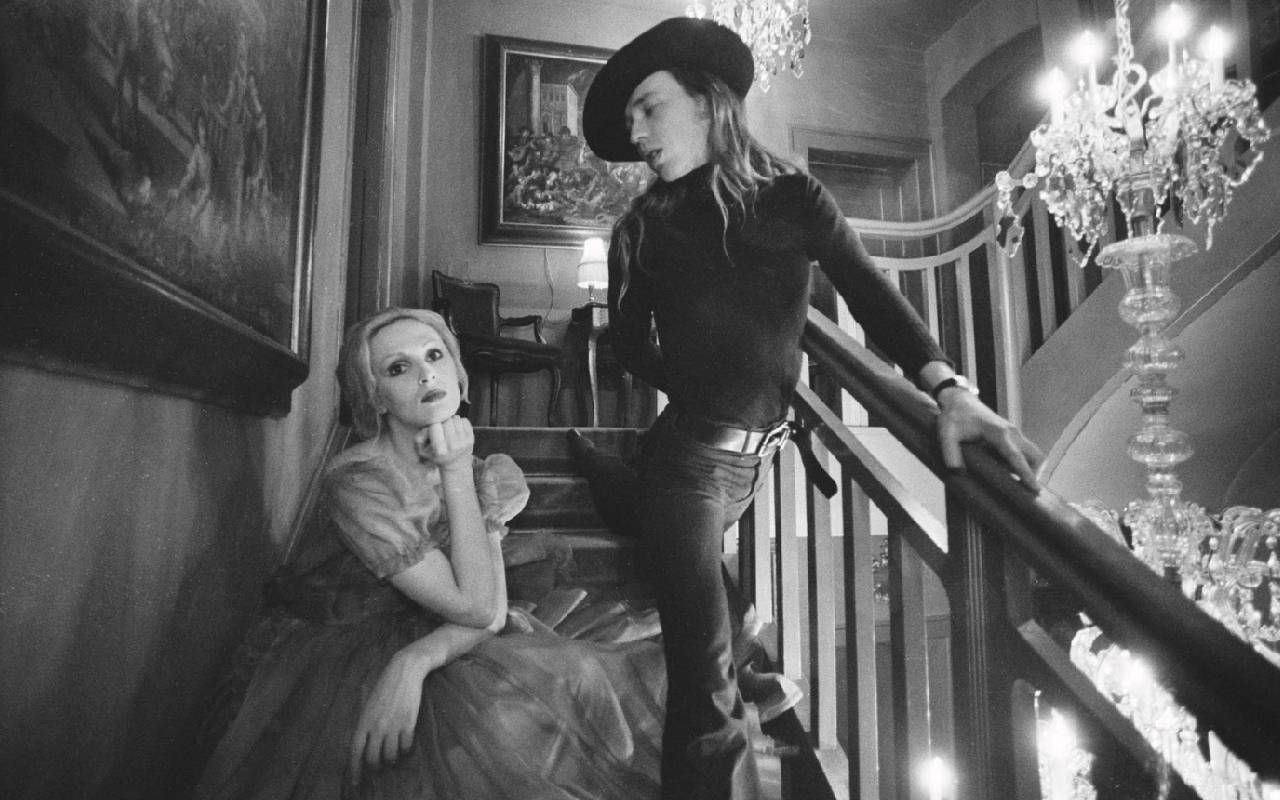 A black and white photo of two people on a staircase. Next Avenue, Candy Darling