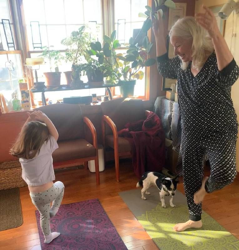 Two people doing yoga. Next Avenue, turning 70