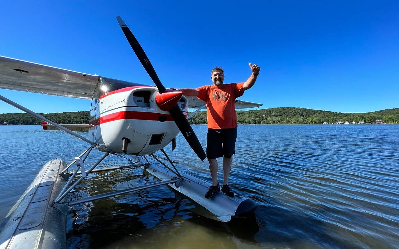 A man smiling while standing on a float plane. Next Avenue, second act career