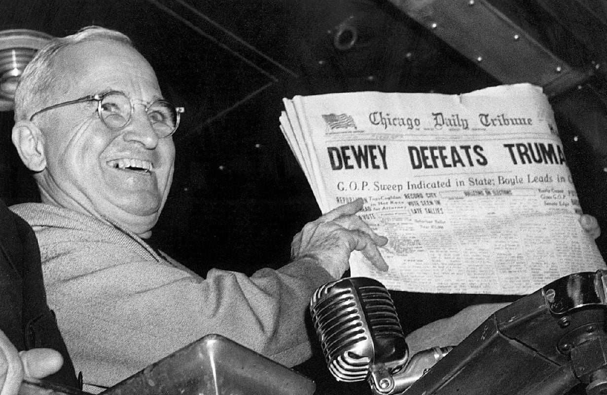President Truman holding up a newspaper and smiling. Next Avenue, election