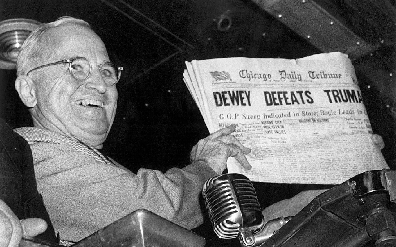 President Truman holding up a newspaper and smiling. Next Avenue, election