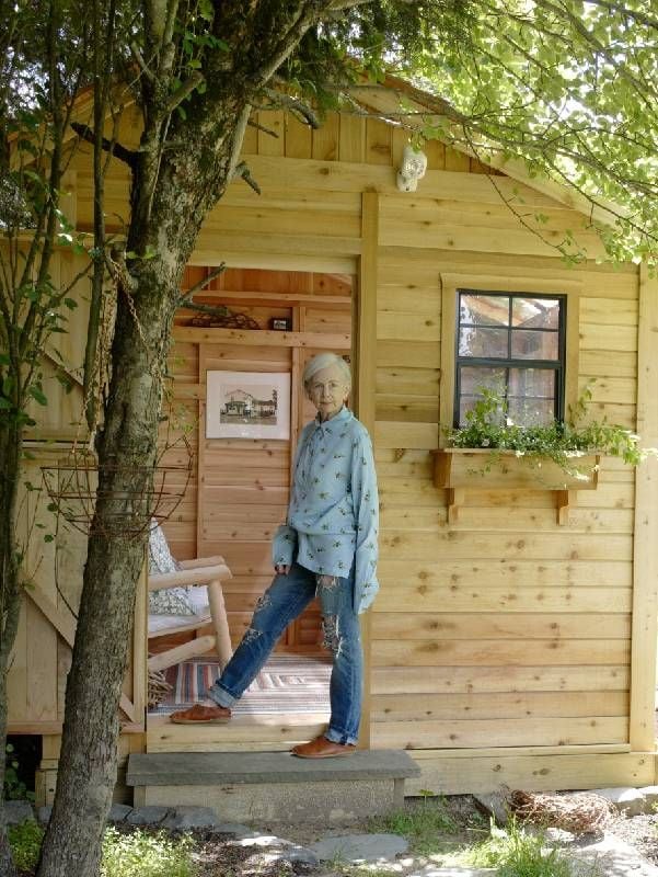 A fashionable older woman standing outside a cabin. Next Avenue, Lyn Slater