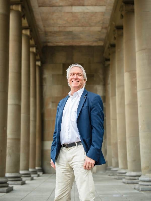 Headshot of a man standing and smiling. Next Avenue, mental health stigma