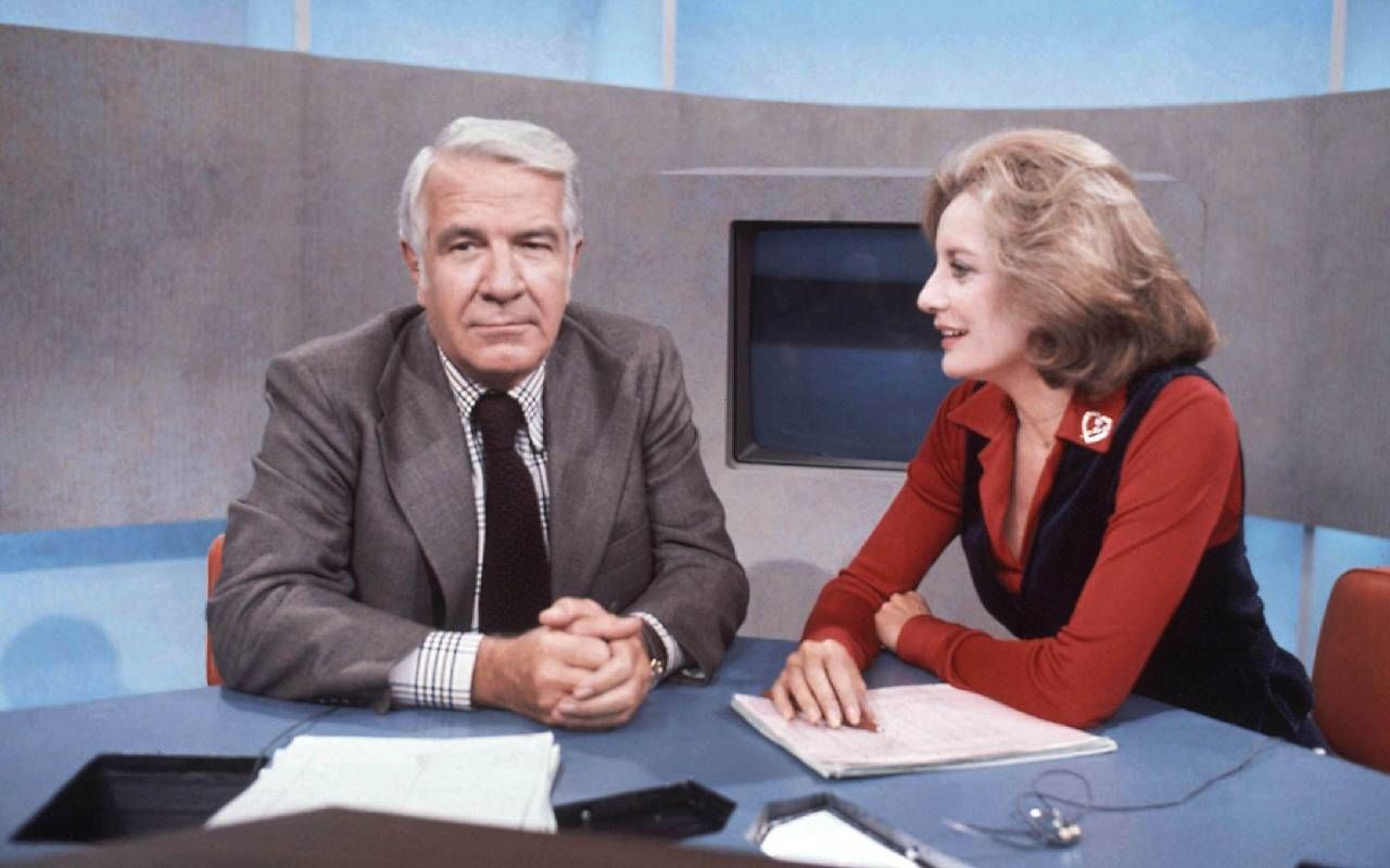 A candid photo of Barbara Walters with a coanchor while on the job. Next Avenue