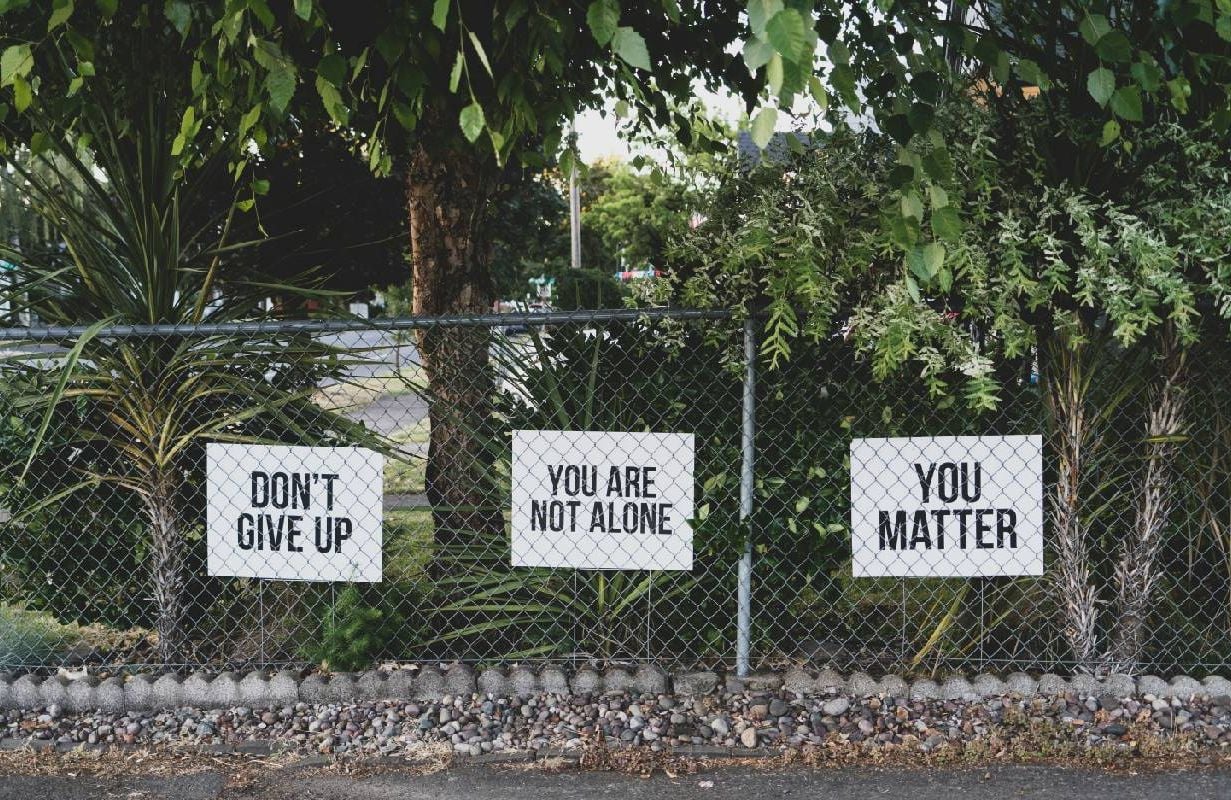 Mental health awareness signs in a person's yard. Next Avenue