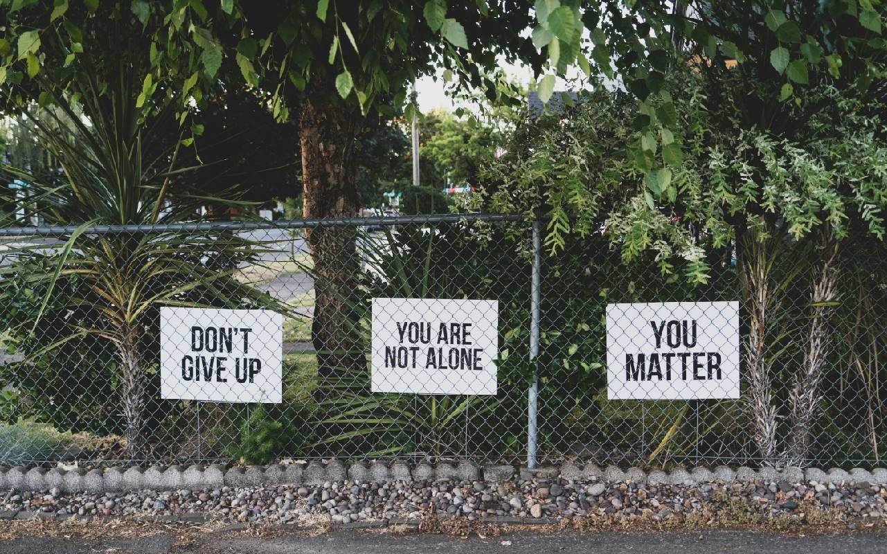 Mental health awareness signs in a person's yard. Next Avenue