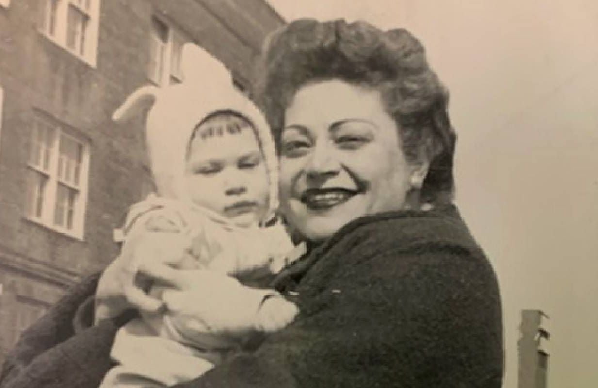 A black and white photo of a woman holding her baby. Next Avenue, mom, mother's day