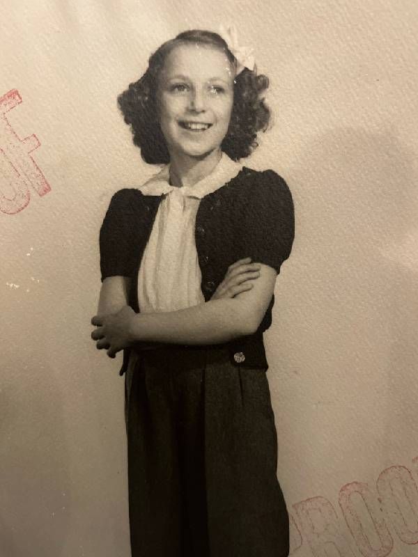 A black and white photo of a young girl smiling. Next Avenue, mother, family history