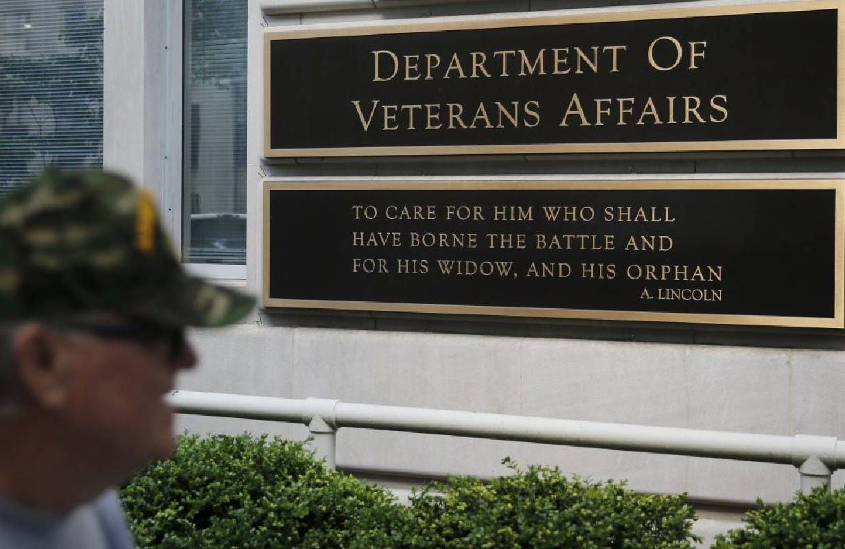 An older vet walking past the Department of Veterans Affairs. Next Avenue, mental health