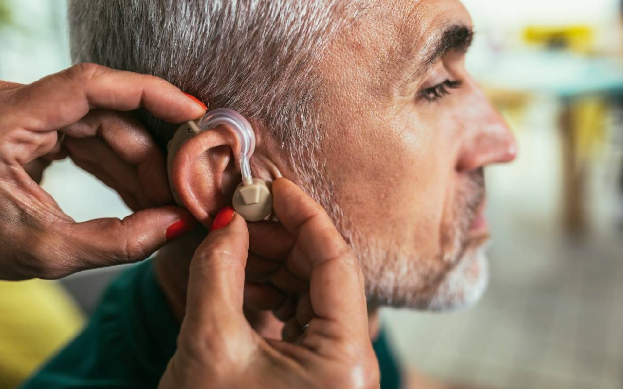 A man getting fitted for a hearing aid. Next Avenue, hearing loss, hearing aids