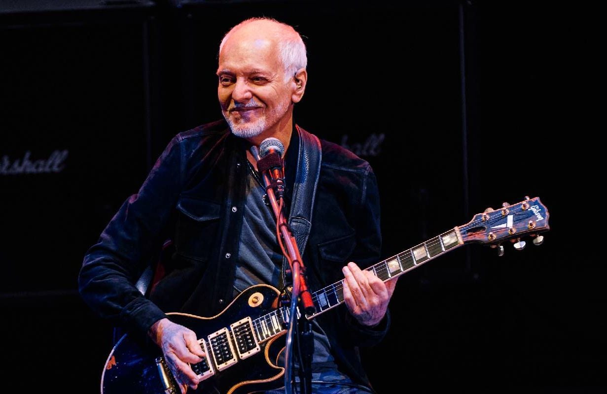 Peter Frampton playing the guitar on stage. Next Avenue