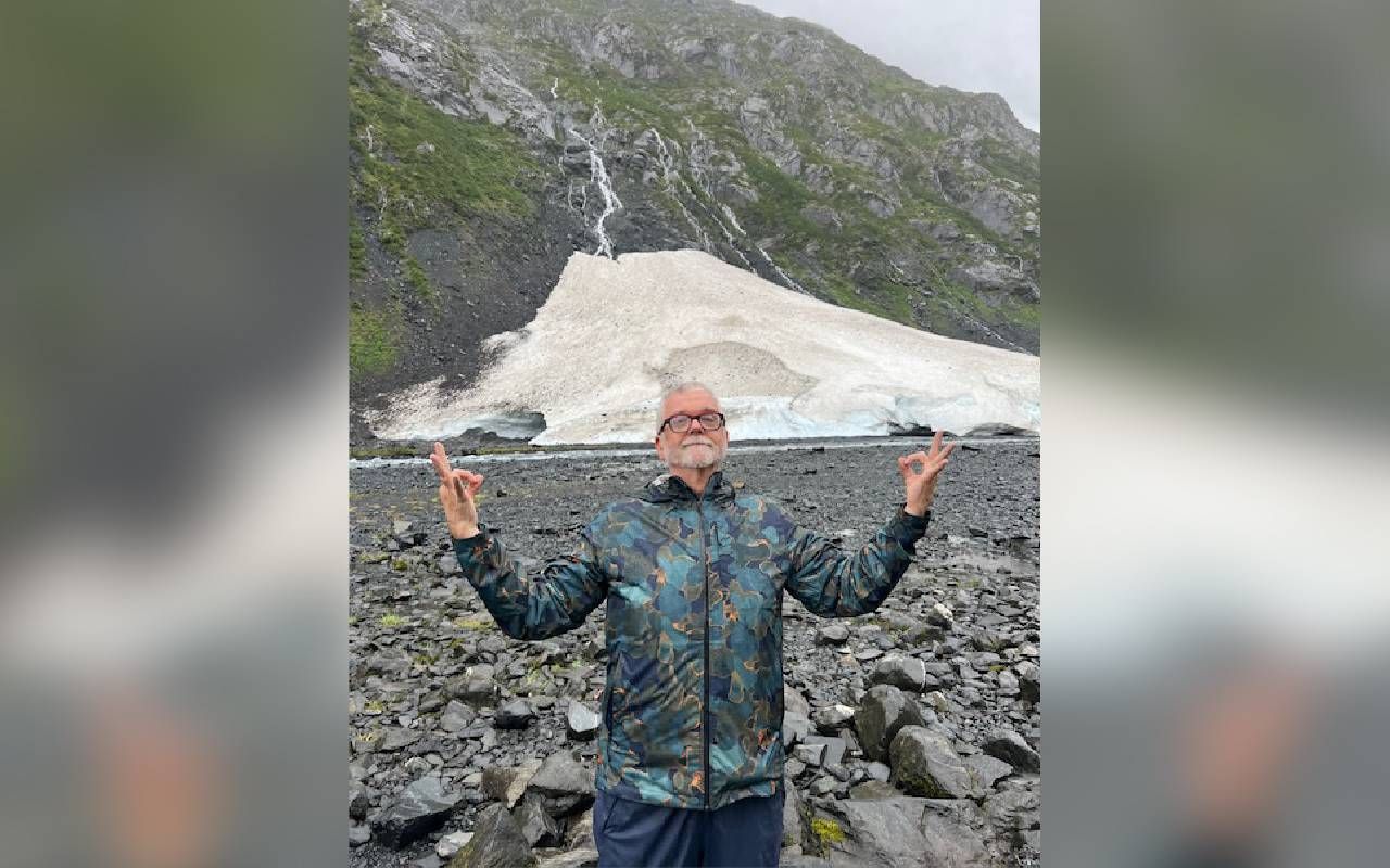 A man posing in front of a glacier. Next Avenue, prostate cancer