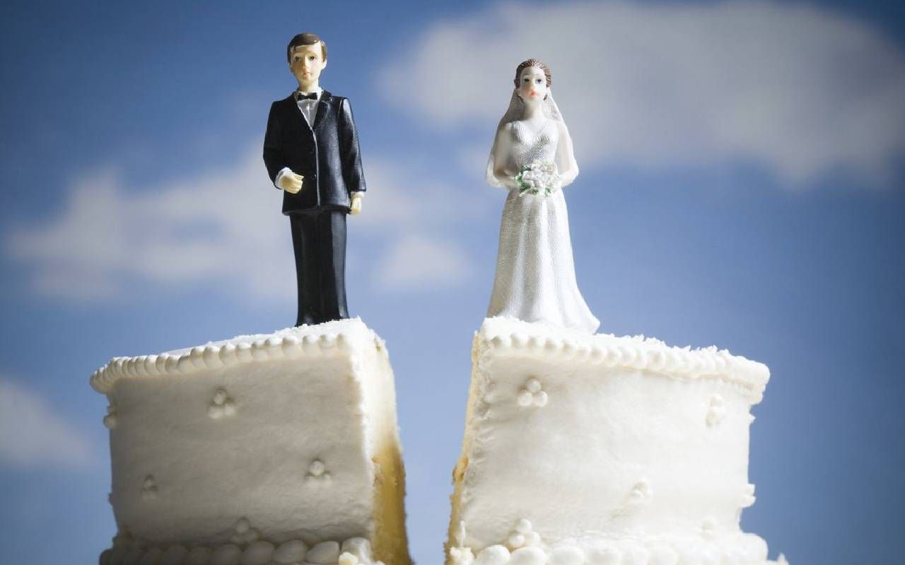 A wedding cake cut down the center. Next Avenue, divorce registry