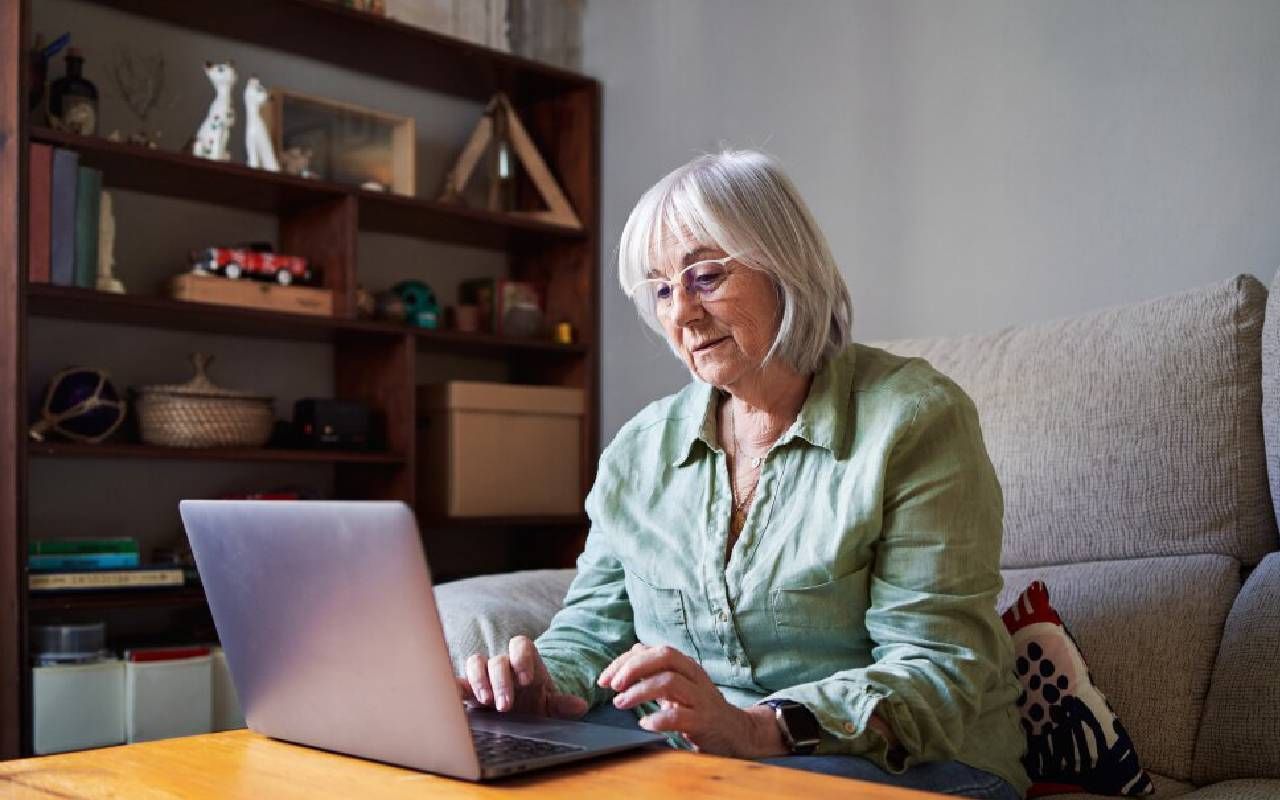 A woman making a plan for her financial future as a solo ager. Next Avenue