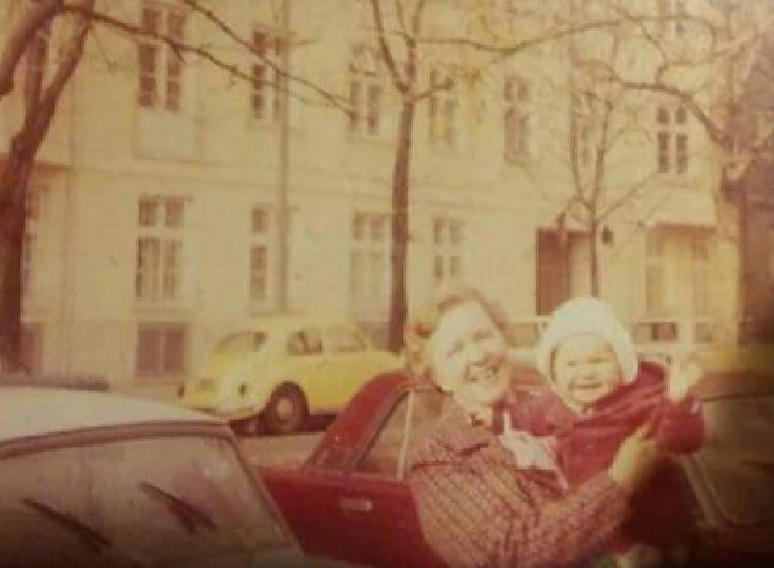 An old photo of a woman holding a young child. Next Avenue, grief road trip