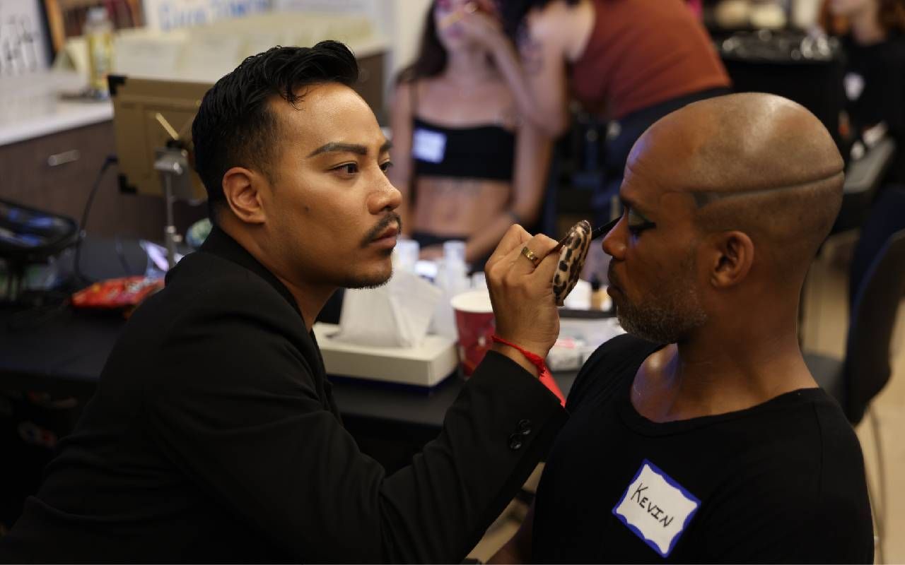A makeup artist putting makeup on an actor. Next Avenue, second act