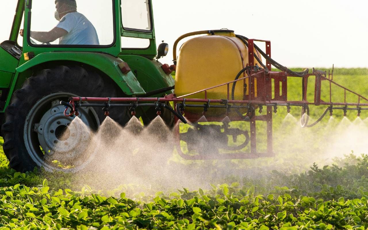 A farmer spraying an herbicide on his crops. Next Avenue, fruits and vegetables pesticides