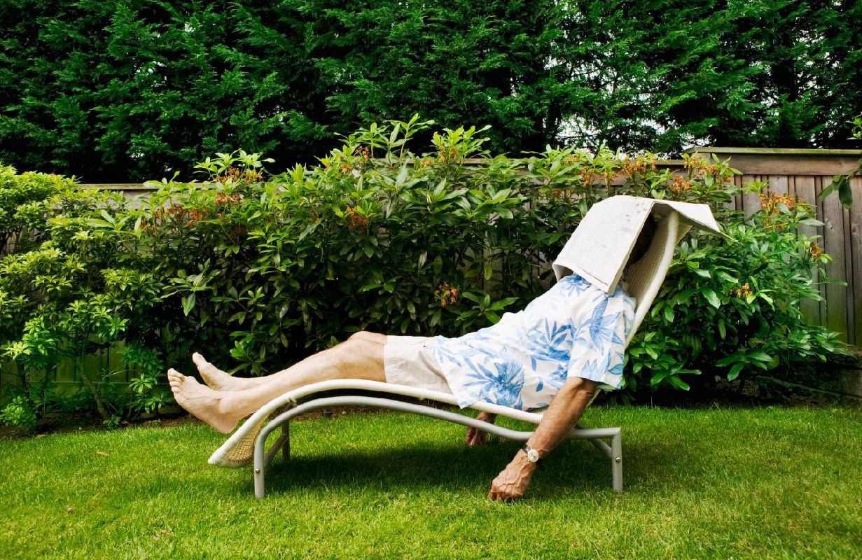 A retired person sleeping with a newspaper. Next Avenue, retired, tired, sleeping
