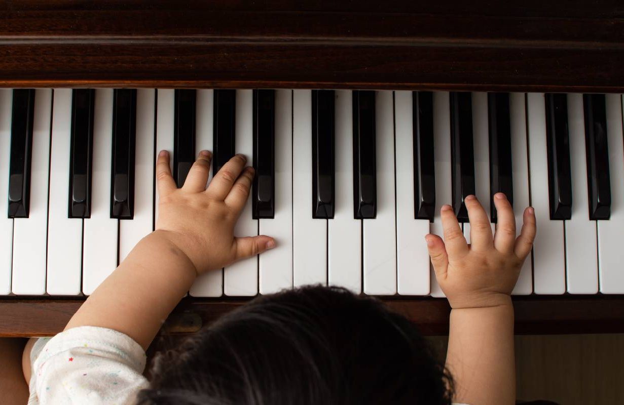 A child playing on a keyboard piano. Next Avenue, bucket list