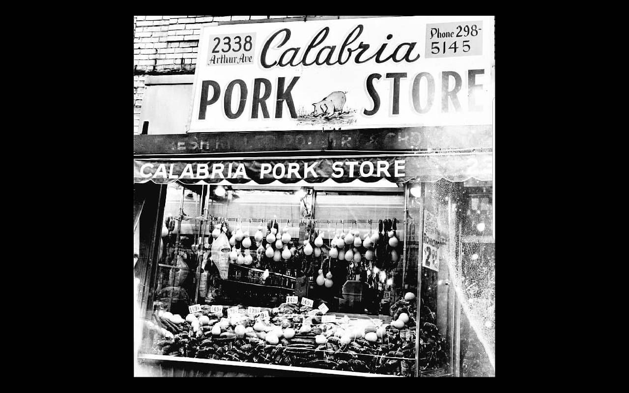 An old photo of a butcher shop. Next Avenue, Arthur Avenue, NYC