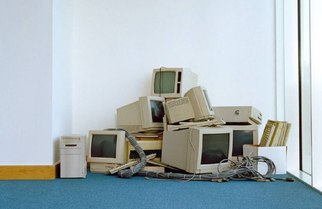 A pile of old computers and monitors. Next Avenue, technology