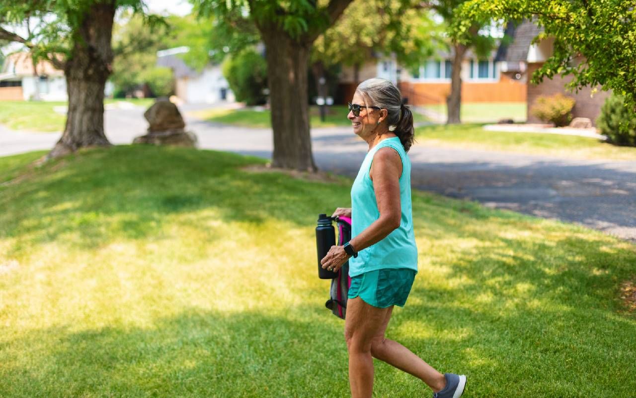A woman walking to a workout class. Next Avenue, fitness routine