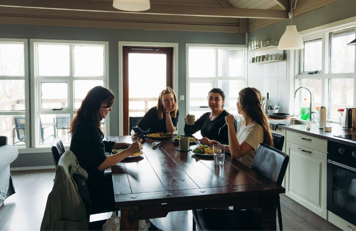 A small group of women smiling together celebrating the holidays. Next Avenue, friendship
