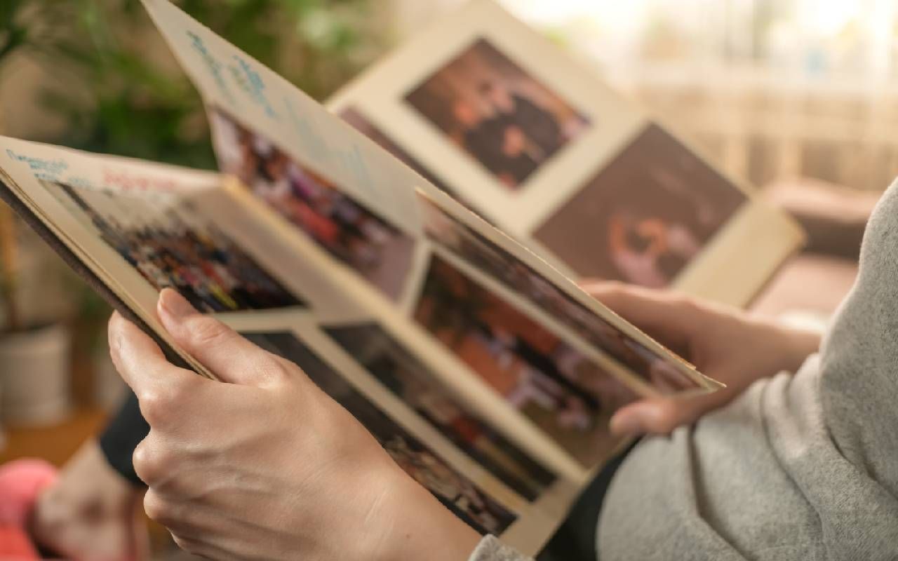 A person looking through a family photo album. Next Avenue, body donation