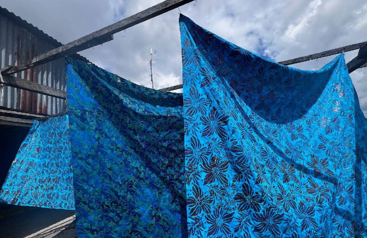 Batiked fabrics drying outside. Next Avenue, batik