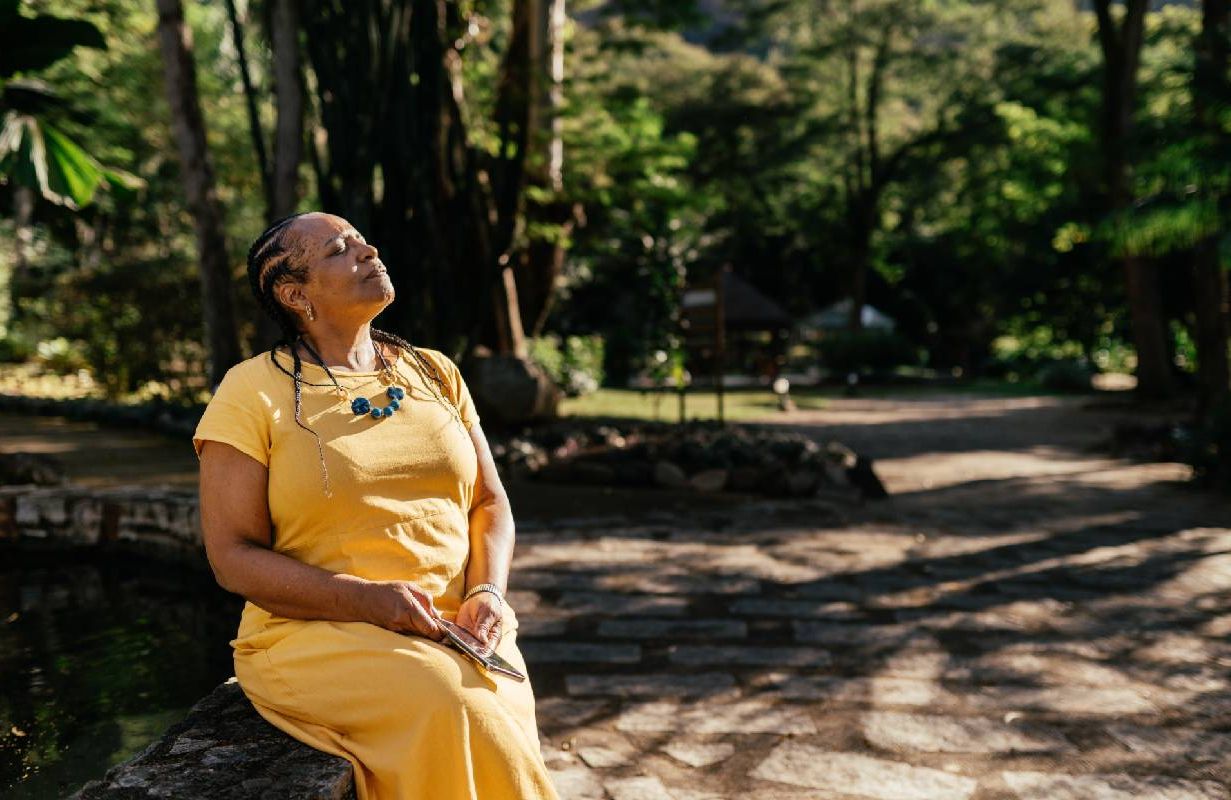 A person taking a moment to breathe in a forest. Next Avenue, purpose