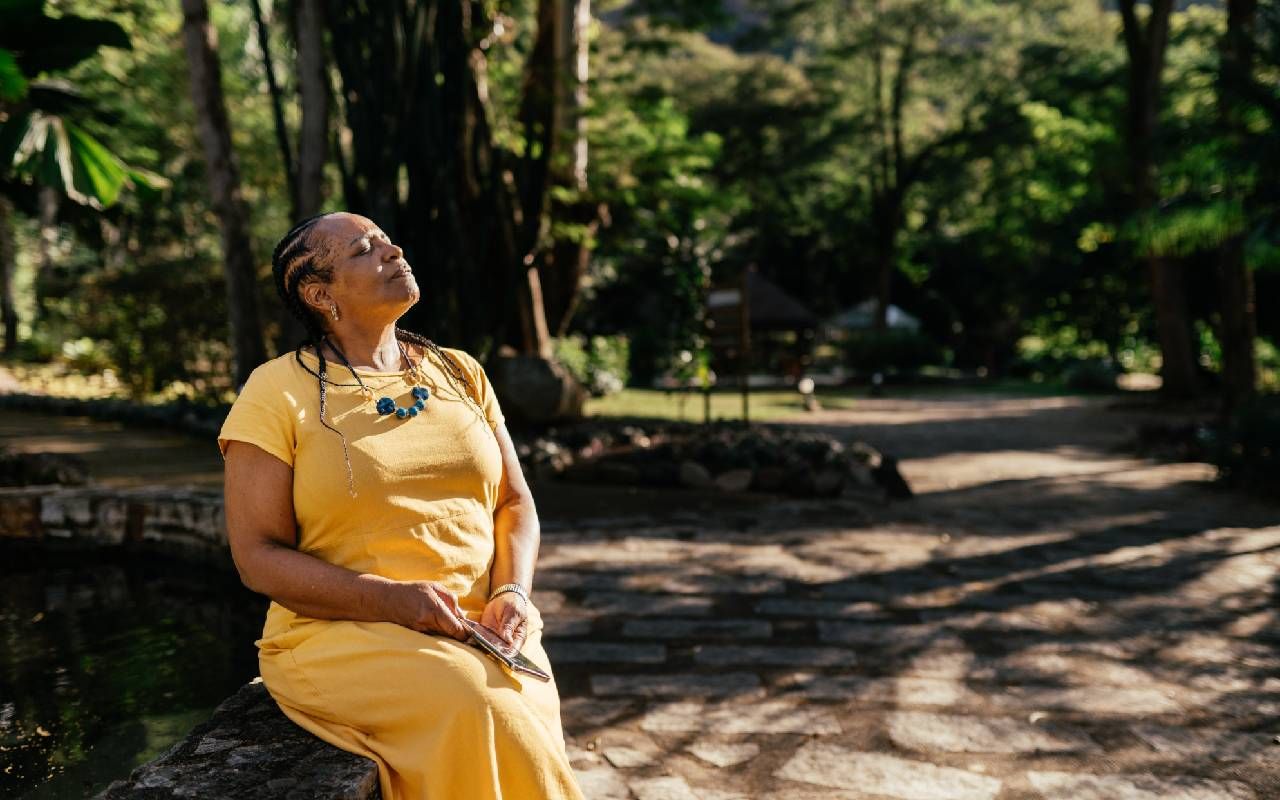 A person taking a moment to breathe in a forest. Next Avenue, purpose