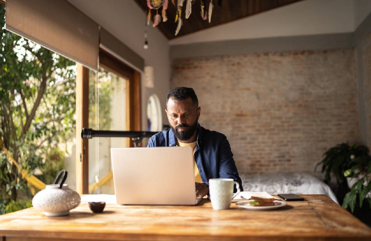 A remote worker on their computer at home. Next Avenue