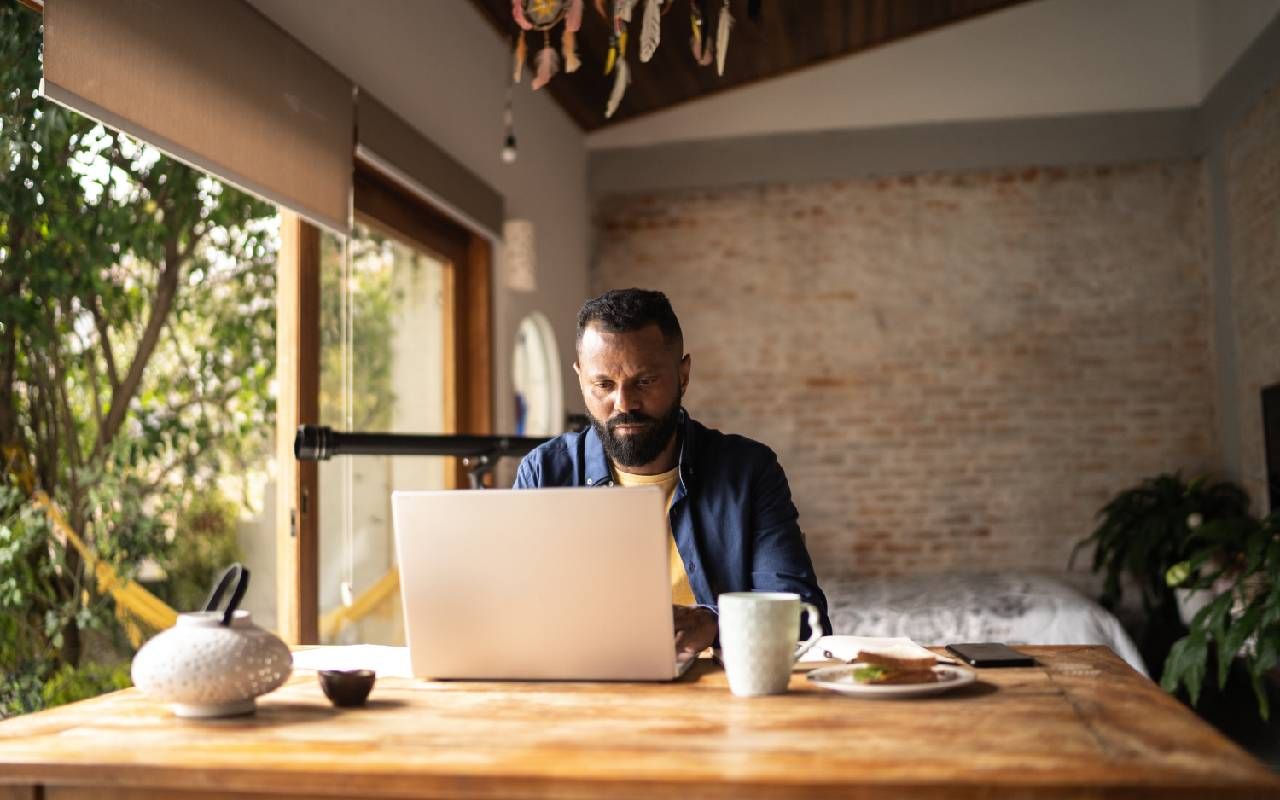 A remote worker on their computer at home. Next Avenue