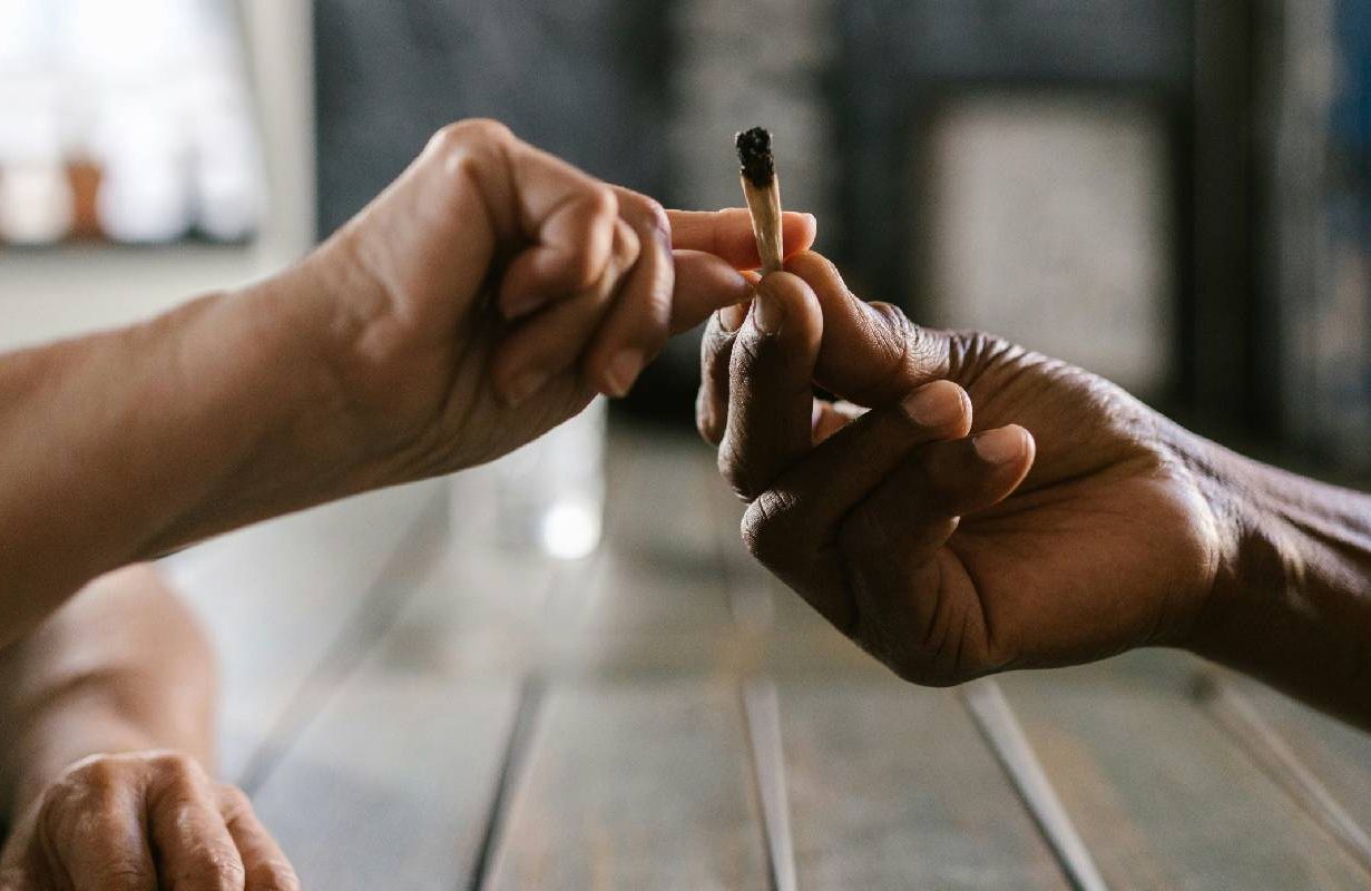 Two older adults passing a joint. Next Avenue, cannabis, weed, marijuana, alcohol