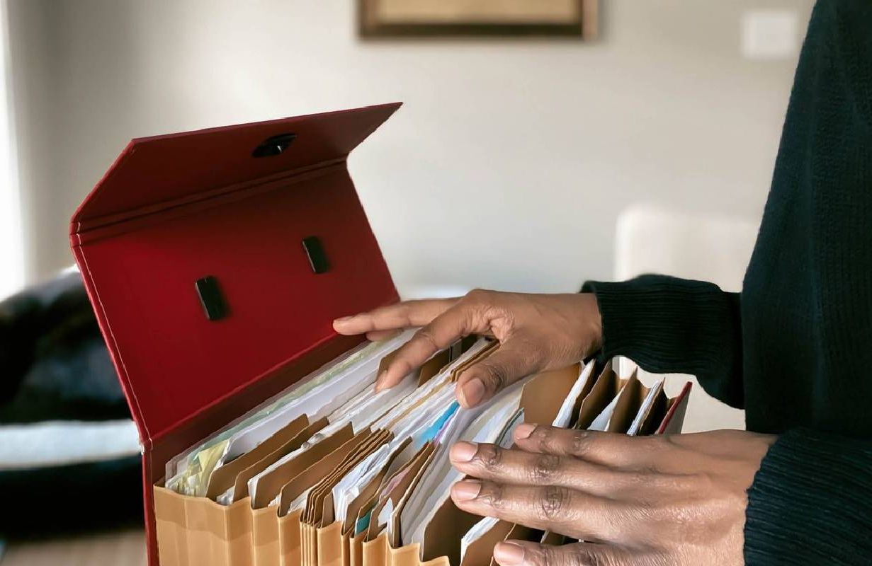 A person going through their personal documents. Next Avenue, finances, separated couples